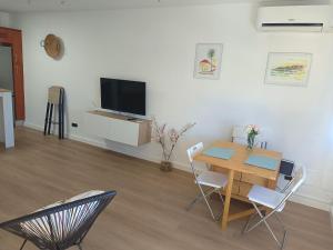 a living room with a table and chairs and a television at Casa Valentina in Tías