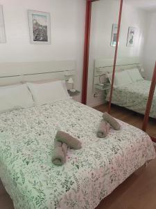 a bedroom with a bed with two slippers on it at Casa Valentina in Tías