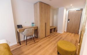 a room with a desk and a chair and a table at Hotel am Rathaus in Freiburg im Breisgau +41 photos