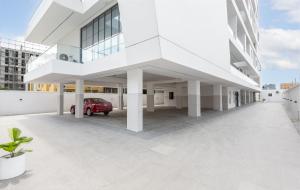 a white building with a red car in a parking lot at Four Two, Rock Drive in Lekki Phase 1