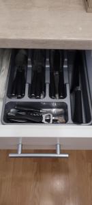 a drawer filled with cooking utensils in a cabinet at Casa Rusu - Govandari -Self check in-24h Netflix in Reşiţa