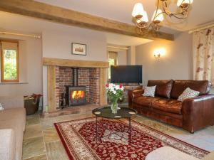 a living room with a couch and a fireplace at Chapelfield in Belper