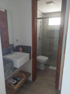 a bathroom with a sink and a toilet at Flecheiras in Trairi +5 photos