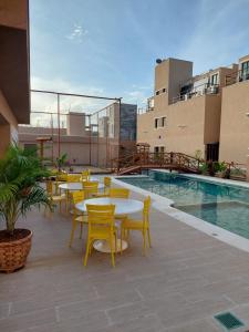 a patio with tables and chairs next to a pool at Flecheiras in Trairi