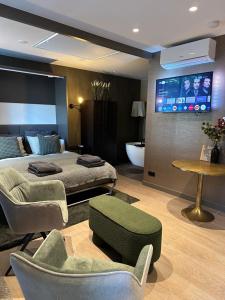a bedroom with a bed and a flat screen tv at City Oasis in The Hague