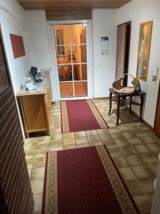 a room with a hallway with a table and a door at Pension Hoffmann in Wuppertal