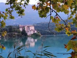 a house on an island in the middle of a lake at Le Betulle in Vezzano