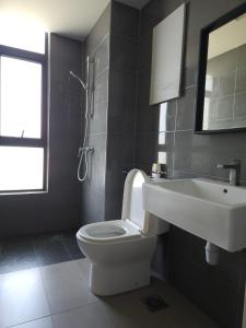 a bathroom with a white toilet and a sink at House Of 99 in Kuantan