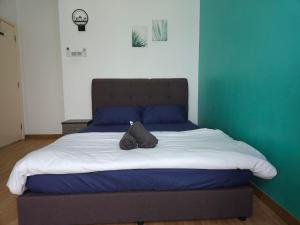 a bed with a pillow on top of it at House Of 99 in Kuantan +7 photos