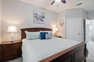 a bedroom with a large bed with blue pillows at 7671 Comrow Unit 205 in Kissimmee