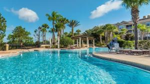 a pool at a resort with palm trees and a gazebo at 7671 Comrow Unit 205 in Kissimmee