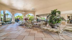 a large lobby with chairs and tables and windows at 7671 Comrow Unit 205 in Kissimmee