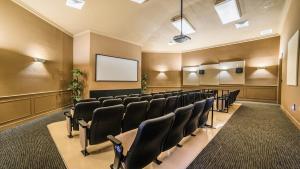 a conference room with chairs and a screen at 7671 Comrow Unit 205 in Kissimmee