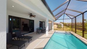 a house with a swimming pool and a patio at Inland home with pool and walk to Park/Museum/Library in Marco Island