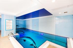 a large swimming pool in a room with blue tiles at Baron Hotel & Spa in Istanbul