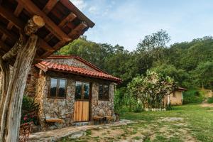 a small stone house with a wooden door in a yard at Jorullo Paradise in Puerto Vallarta