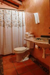 a bathroom with a toilet and a sink at Jorullo Paradise in Puerto Vallarta