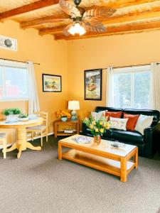 a living room with a couch and a table at Riverview Cozy Home by the River in Klamath +2 photos