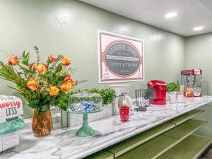 a counter with flowers and other items on it at Riverview Cozy Home by the River in Klamath
