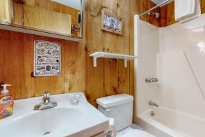 a bathroom with a sink and a toilet and a tub at Dover Green 15F in Dover +54 photos