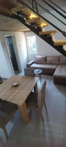 a living room with a wooden table and a couch at Apartman Anđela 4 in Vrdnik