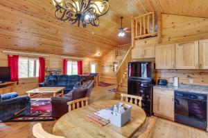 a dining room and living room in a log cabin at Deadwood Cabin with Foosball Table, Near Sanford Lab in Deadwood