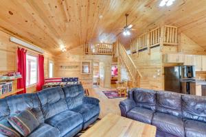a living room with leather furniture in a log cabin at Deadwood Cabin with Foosball Table, Near Sanford Lab in Deadwood