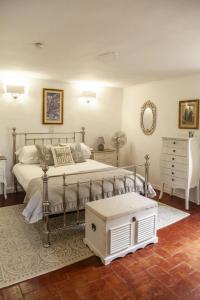a bedroom with a bed and a dresser at Casa Luna - Private Cottage -Exclusive Private Garden in Barga