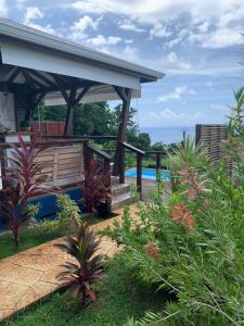 a patio with a gazebo and a pool at Le Jardin Zen in Bouillante