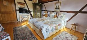 a bedroom with a bed and a television in it at Au Verger des Louves in Helfrantzkirch