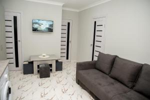 a living room with a couch and a table at EKA House in Goris