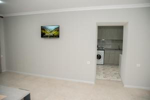 a room with a white wall with a picture on it at EKA House in Goris