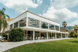 an office building with glass windows and palm trees at Bahia Escondida in Santiago