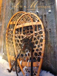 a wine rack filled with wine bottles in the snow at Hôtel Quin Te Va in Cauterets