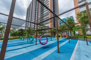 a group of olympic rings on a blue floor with buildings at Emerald Hill Kuala Lumpur by HLG in Kuala Lumpur