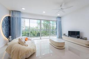 a living room with a couch and a large window at Emerald Hill Kuala Lumpur by HLG in Kuala Lumpur