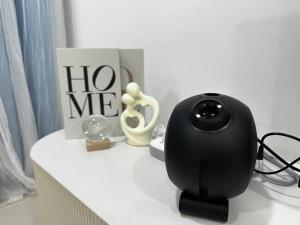 a black webcam sitting on a white table with a sign at Emerald Hill Kuala Lumpur by HLG in Kuala Lumpur