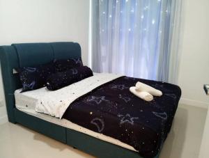 a bed with two white towels on top of it at Emerald Hill Kuala Lumpur by HLG in Kuala Lumpur