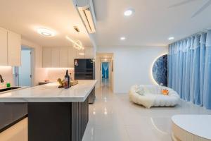 a kitchen with a large island in the middle of a room at Emerald Hill Kuala Lumpur by HLG in Kuala Lumpur