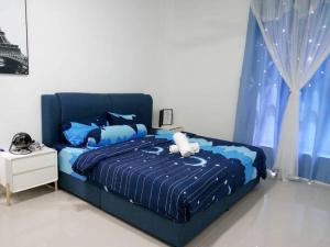 a blue bed with a stuffed animal sitting on it at Emerald Hill Kuala Lumpur by HLG in Kuala Lumpur