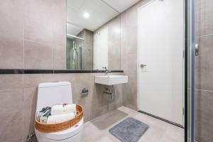 a bathroom with a toilet and a sink at Emerald Hill Kuala Lumpur by HLG in Kuala Lumpur