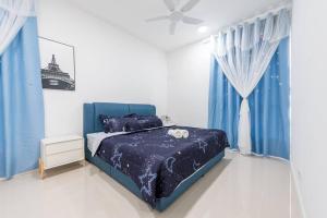 a bedroom with a blue bed and blue curtains at Emerald Hill Kuala Lumpur by HLG in Kuala Lumpur