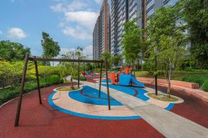 a playground with a slide in a park at Emerald Hill Kuala Lumpur by HLG in Kuala Lumpur