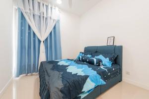a bedroom with a bed with blue comforter and a window at Emerald Hill Kuala Lumpur by HLG in Kuala Lumpur +32 photos