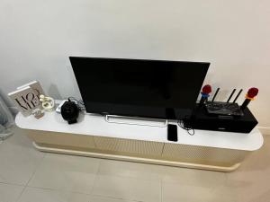 a flat screen tv sitting on top of a table at Emerald Hill Kuala Lumpur by HLG in Kuala Lumpur
