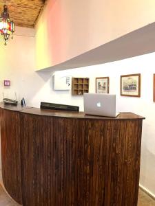 an office counter with a laptop on top of it at Riyad zen oasis in Essaouira