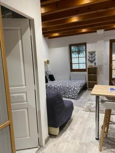 a bedroom with two beds and a door with a table at Fouettara 2 in Firminy
