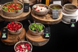 a display of bowls of vegetables on wooden plates at Landgoed De Wilmersberg in De Lutte +53 photos