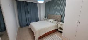 a small bedroom with a bed and a night stand at RIVAS FCA-PARIS TERRAZA apt in Rivas-Vaciamadrid +24 photos