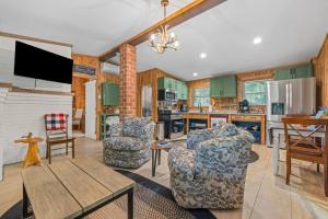 a living room with two chairs and a table at Heron Hideout! Shenandoah Riverfront Retreat! in Oak Hill